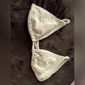 This is a bathing suit from pacsun it’s textured with flower designs light blue